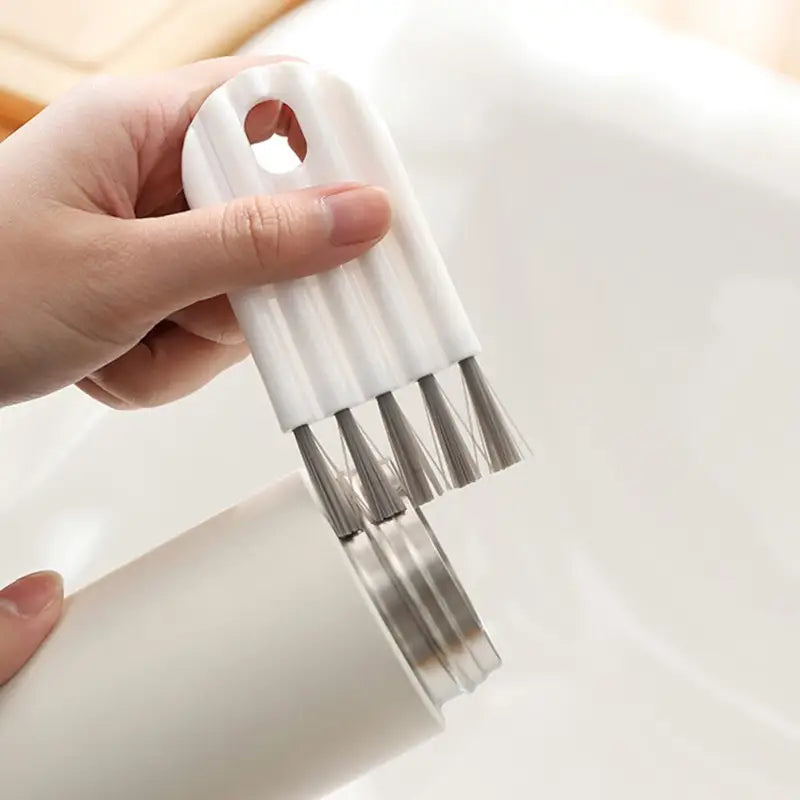 a person is holding a white soap bottle