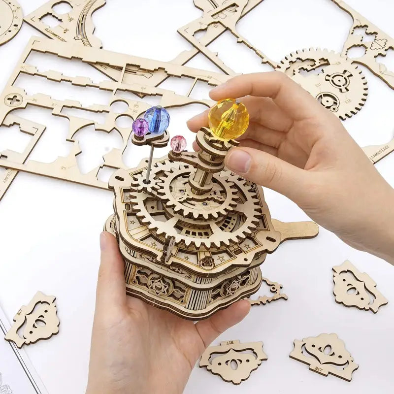 a person is holding a wooden clock