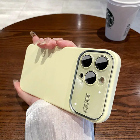 a person holding a yellow iphone case