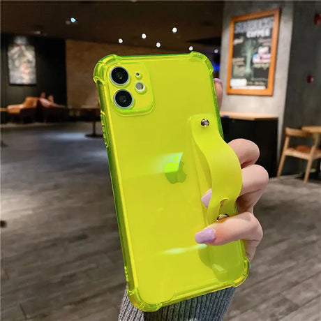 a person holding a yellow iphone case