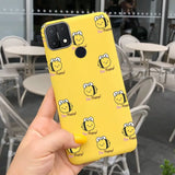 a person holding up a yellow phone case with smiley faces