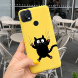 a person holding up a yellow phone case with a black cat on it