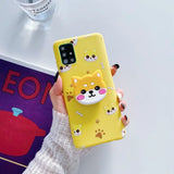 a person holding a yellow phone case with a cat on it