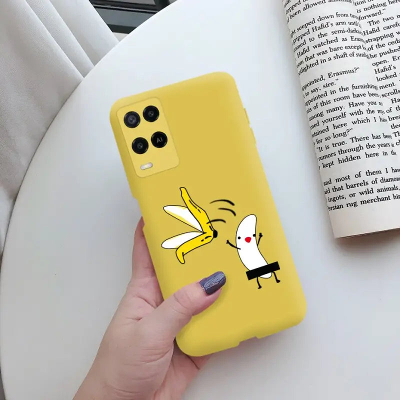 a person holding a yellow phone case with a cartoon character on it