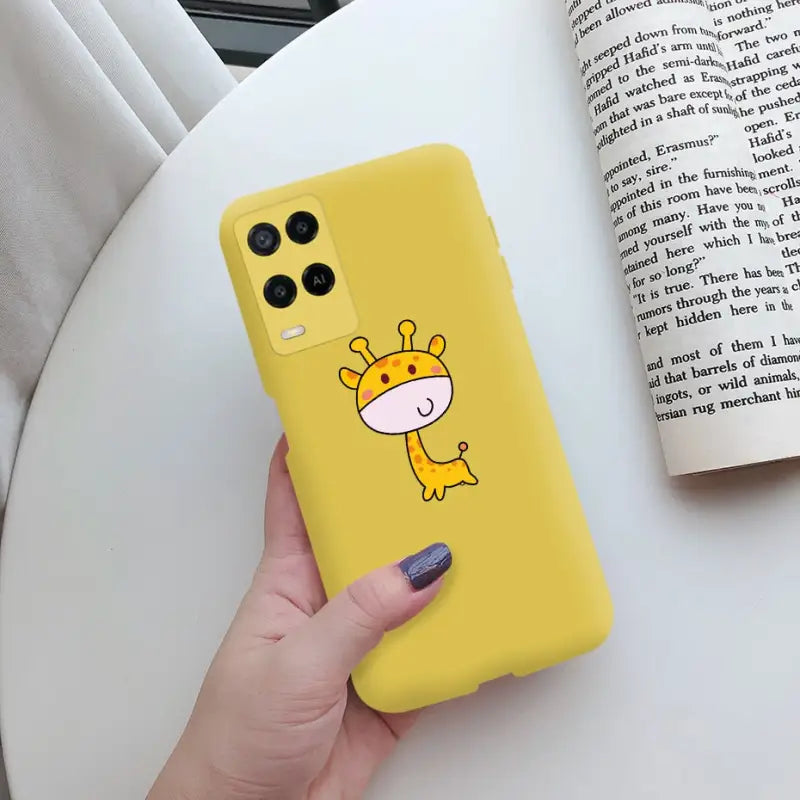 a hand holding a yellow phone case with a cartoon gi