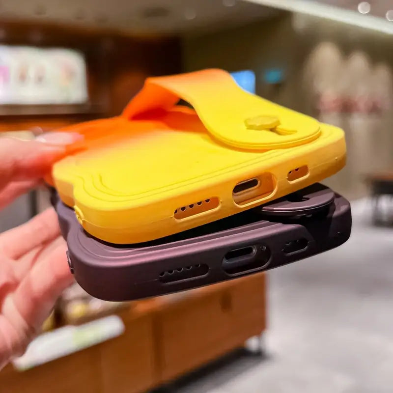 a person holding a yellow and purple case