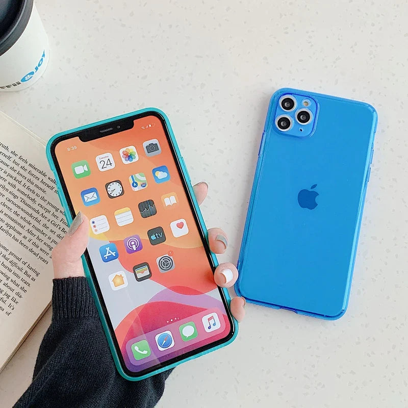 a person holding an iphone case with a book and coffee