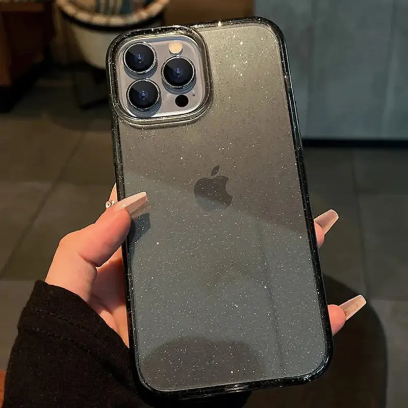 a person holding an iphone case with glitter on it