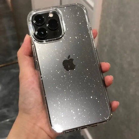 A person holding an iphone case with glitter on it