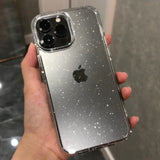 a person holding an iphone case with glitter on it