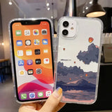 A person holding an iphone case with a picture of a landscape