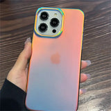 a person holding an iphone case with a rainbow colored design