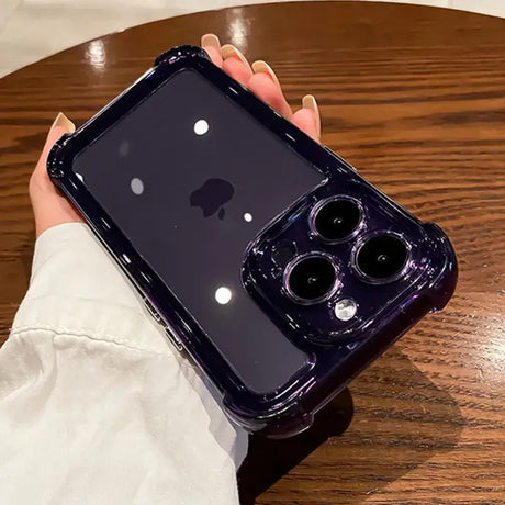 A person holding an iphone case on a table