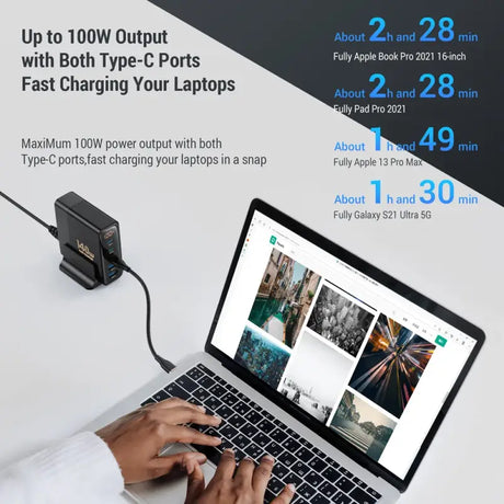 A person using a laptop with a power cord
