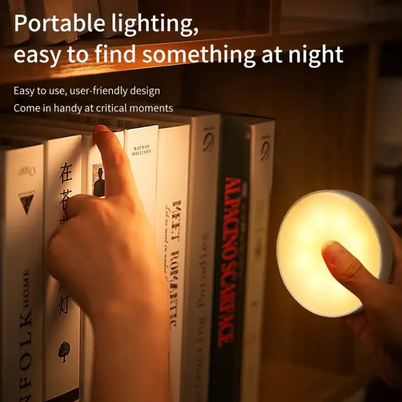 a person is putting a light on a book shelf