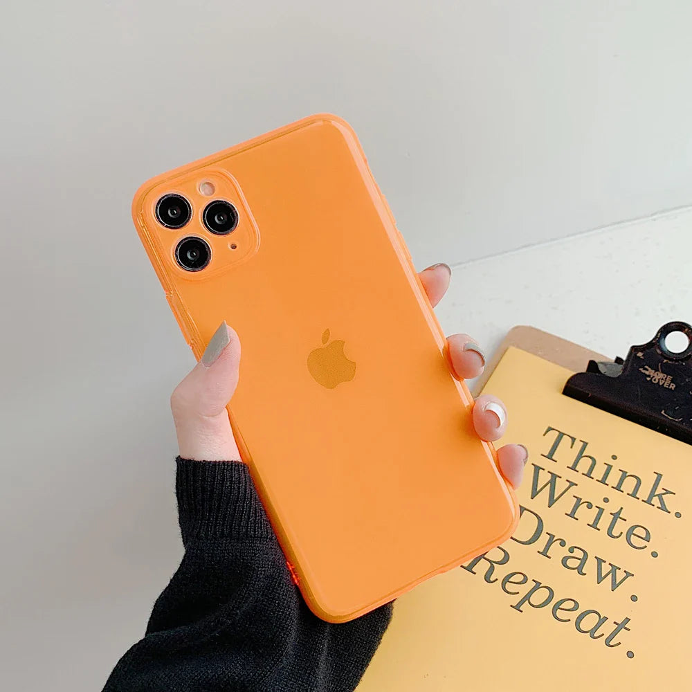 a person holding an orange iphone case