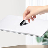 a person using a pen to write on a white paper