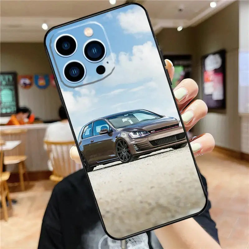 a person holding a phone with a car on it