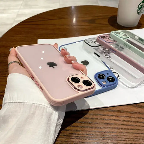 A person holding a phone case with a phone in the background