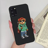 a person holding a phone case with a bear