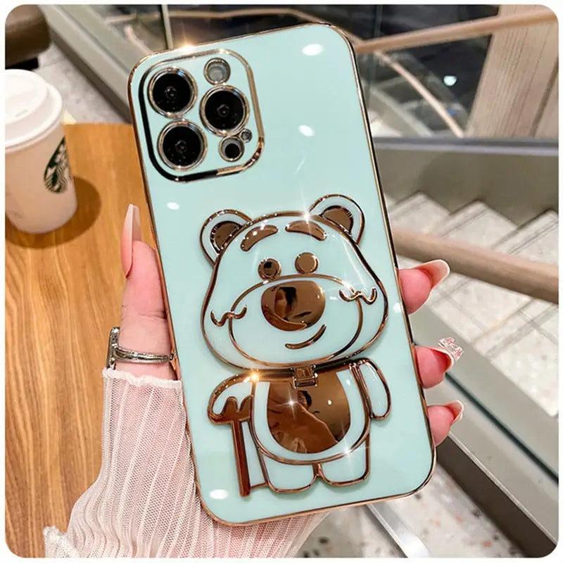 A person holding a phone case with a bear on it