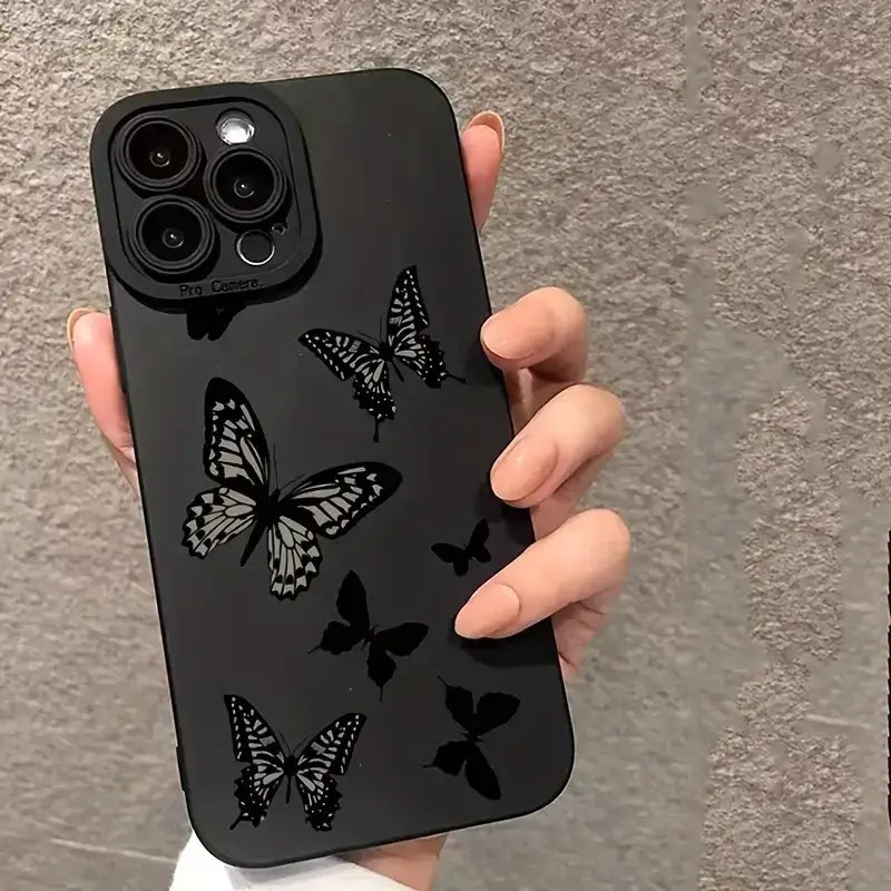 a person holding a phone case with a black and white pattern