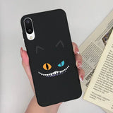 a person holding a phone case with a black cat face