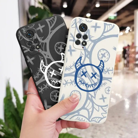 A person holding a phone case with a blue and white design