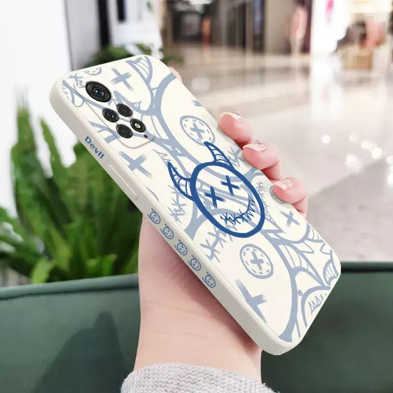 a person holding a phone case with a blue and white design