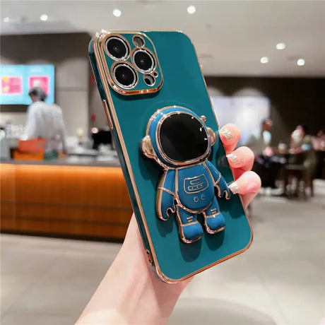 A person holding a phone case with a blue astronaut