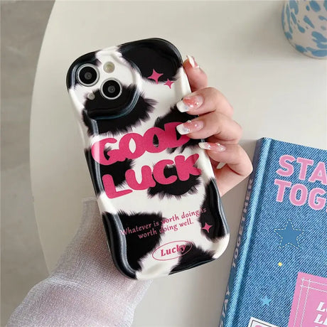 A person holding a phone case with a book