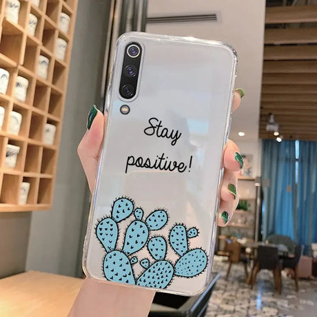 A person holding a phone case with a cactus on it