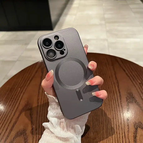 A person holding a phone case with a camera