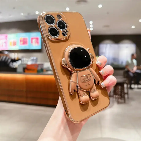 A person holding a phone case with a camera