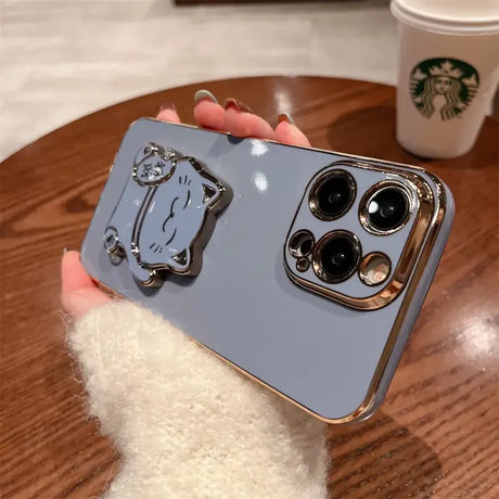 A person holding a phone case with a camera