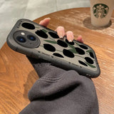 a person holding a phone case with a camouflage print
