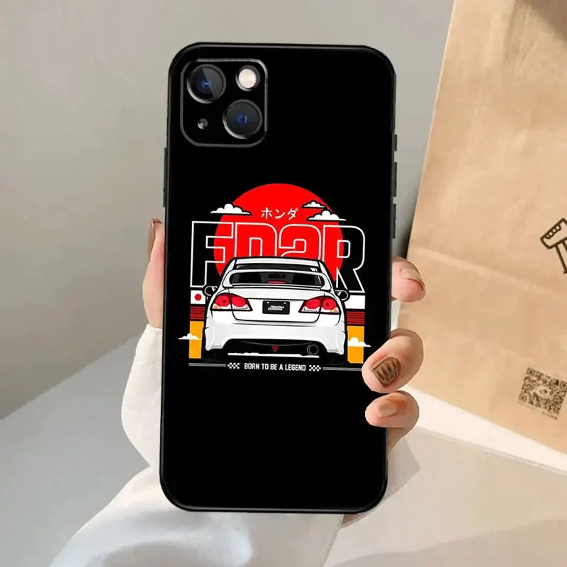 a person holding a phone case with a car