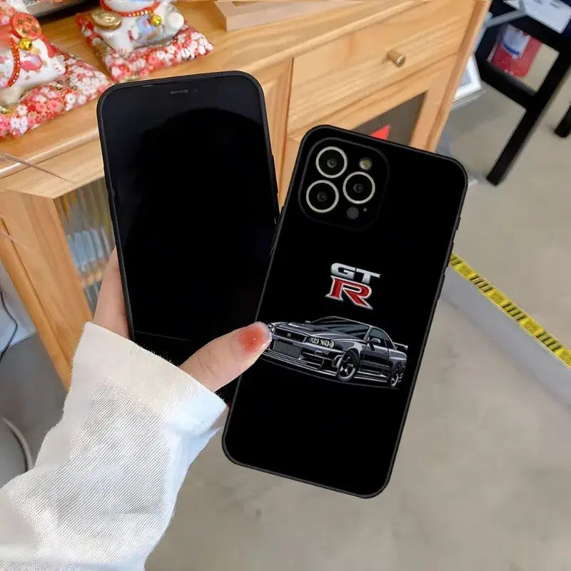 a person holding a phone case with a car on it