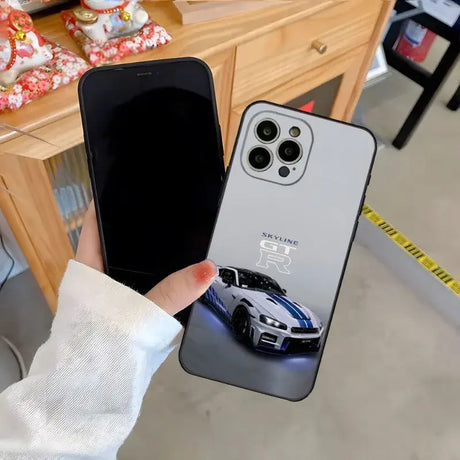 A person holding a phone case with a car on it