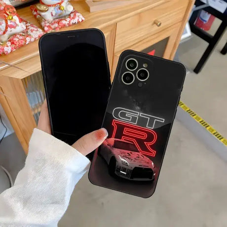 A person holding a phone case with a car on it