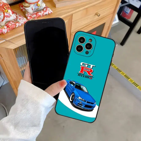 A person holding a phone case with a car on it