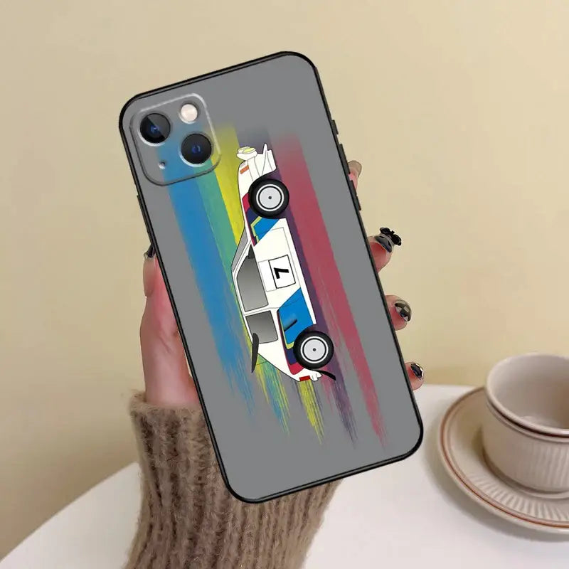 a person holding a phone case with a car painted on it