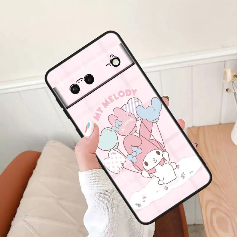 A person holding a phone case with a cartoon character