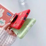 a person holding a phone case with a cartoon character design