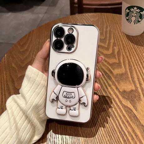A person holding a phone case with a cartoon character on it
