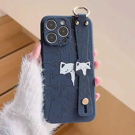 A person holding a phone case with a cat on it