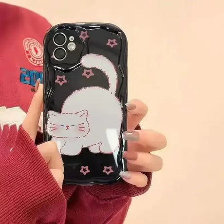 A person holding a phone case with a cat on it