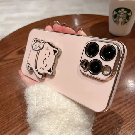 A person holding a phone case with a cat on it