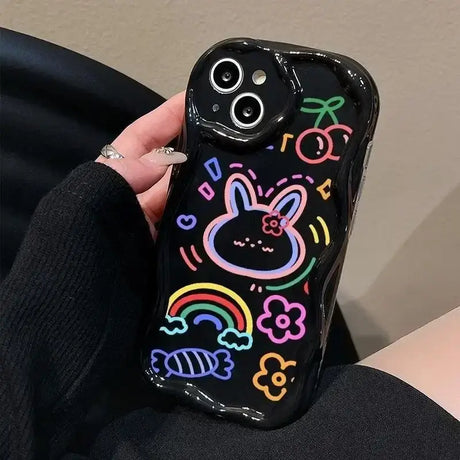 A person holding a phone case with a drawing on it