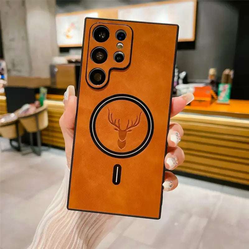 a person holding a phone case with a deer head